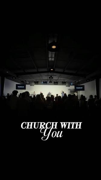 Congregation worshipping in a darkened sanctuary
